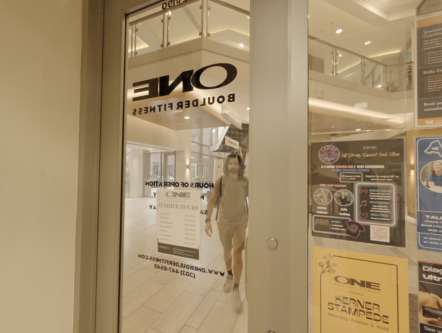 A member walking into the ONE Boulder Fitness entrance in downtown Boulder