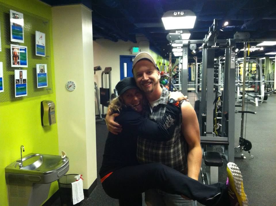Two longtime members hugging on the gym floor