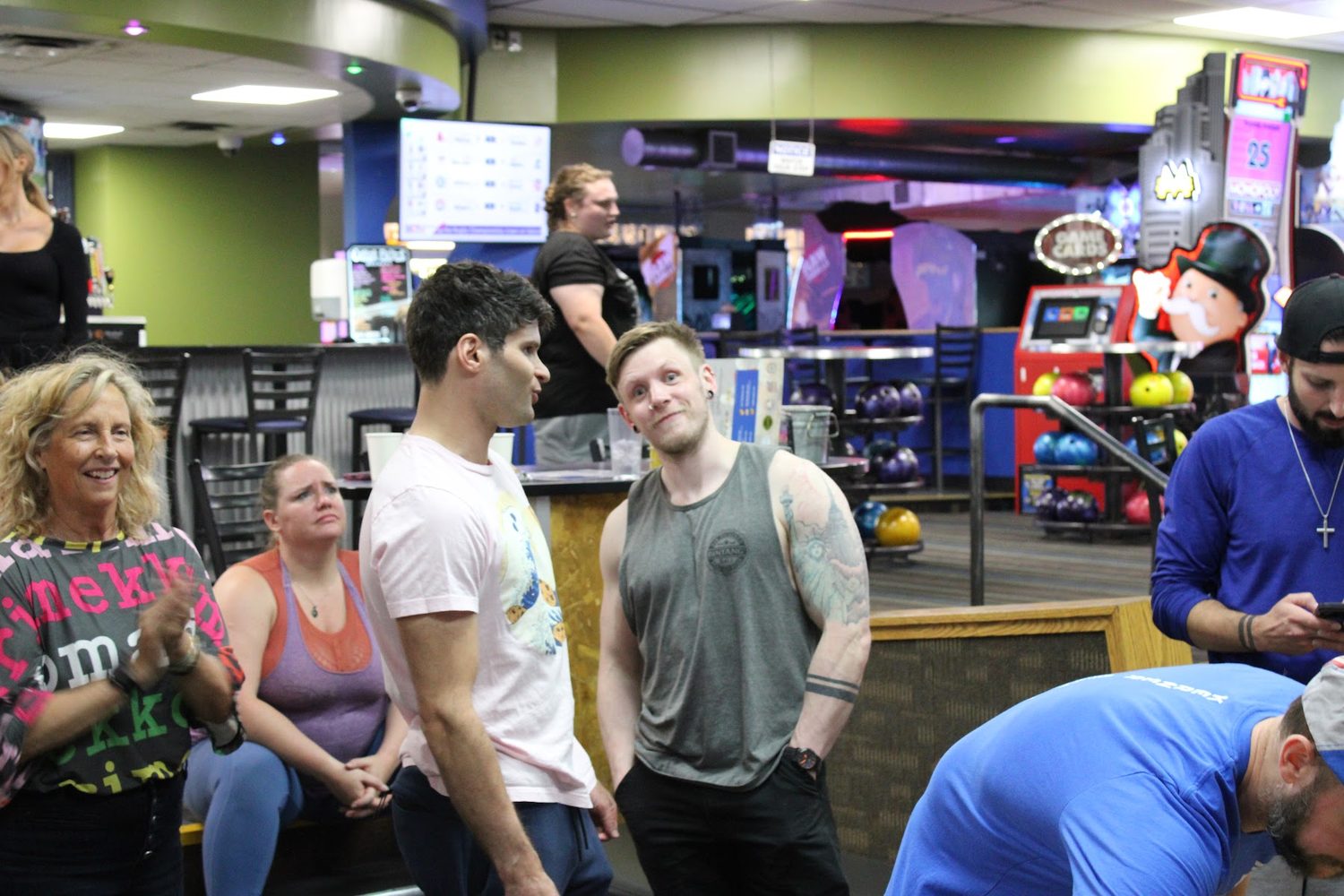 Members hanging out and laughing together on the club's bowling night