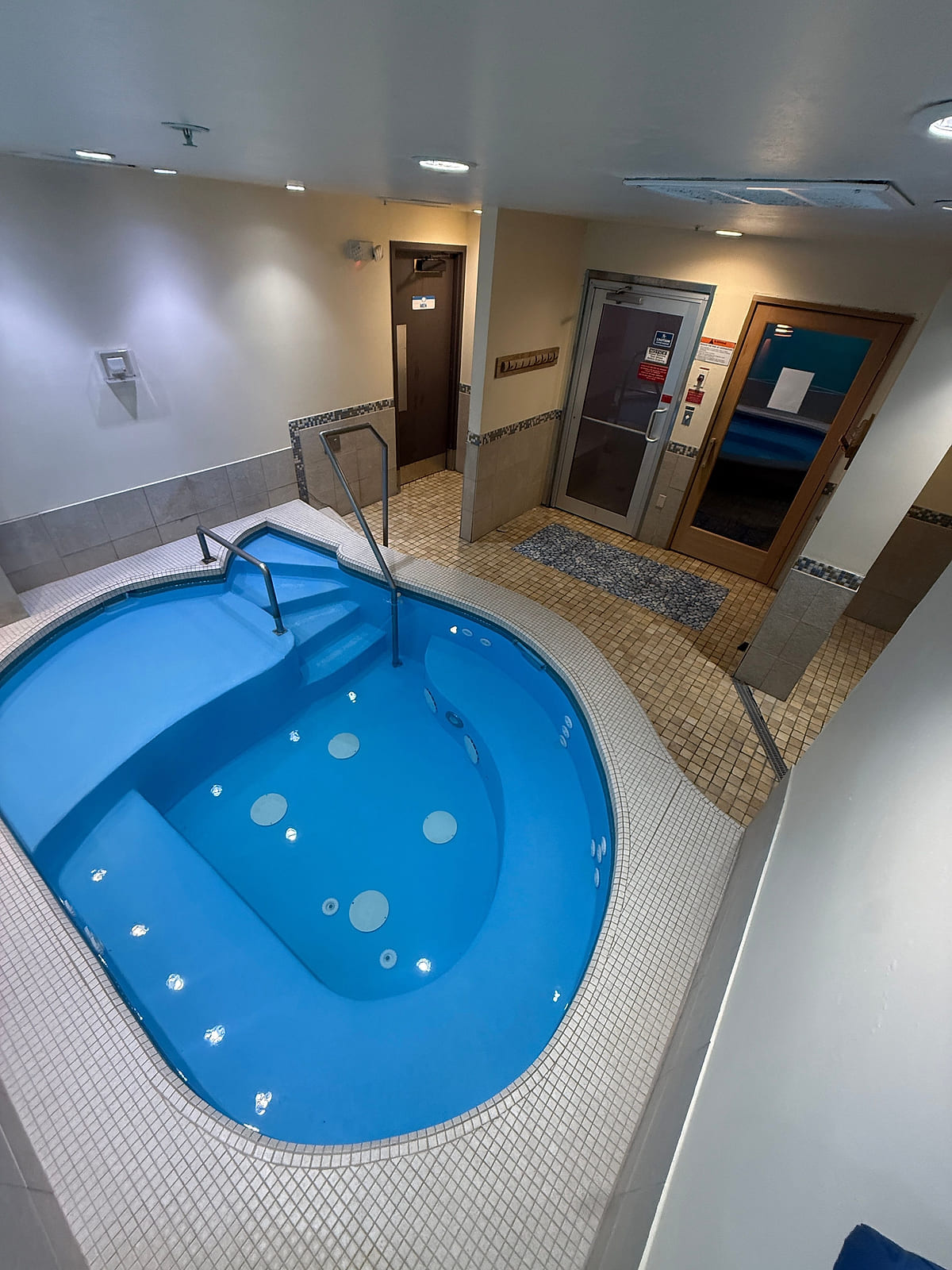 The Cool Tub at ONE Boulder Fitness with tiled steps and handrails leading down into the water